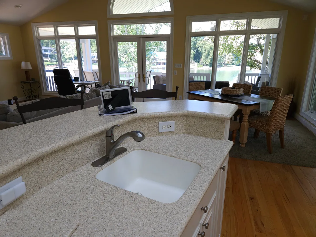 This interior shot showcases the kitchen sink and dining table with large windows in the background, opening up to the living area. The space feels bright and welcoming, ideal for both everyday family life and entertaining guests.